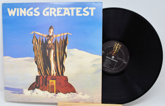 Vinyl record with cover titled 'Wings Greatest' featuring a statue on a cloud.