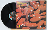 Vinyl record with a colorful cover featuring red beans on a light gray background