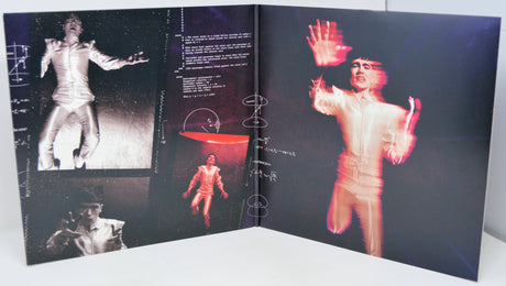 Open book with black and white and red images of a person in a suit on a dark background