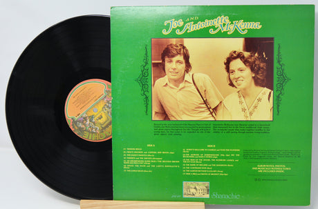 Vinyl record with green cover featuring a couple and album details on a white background