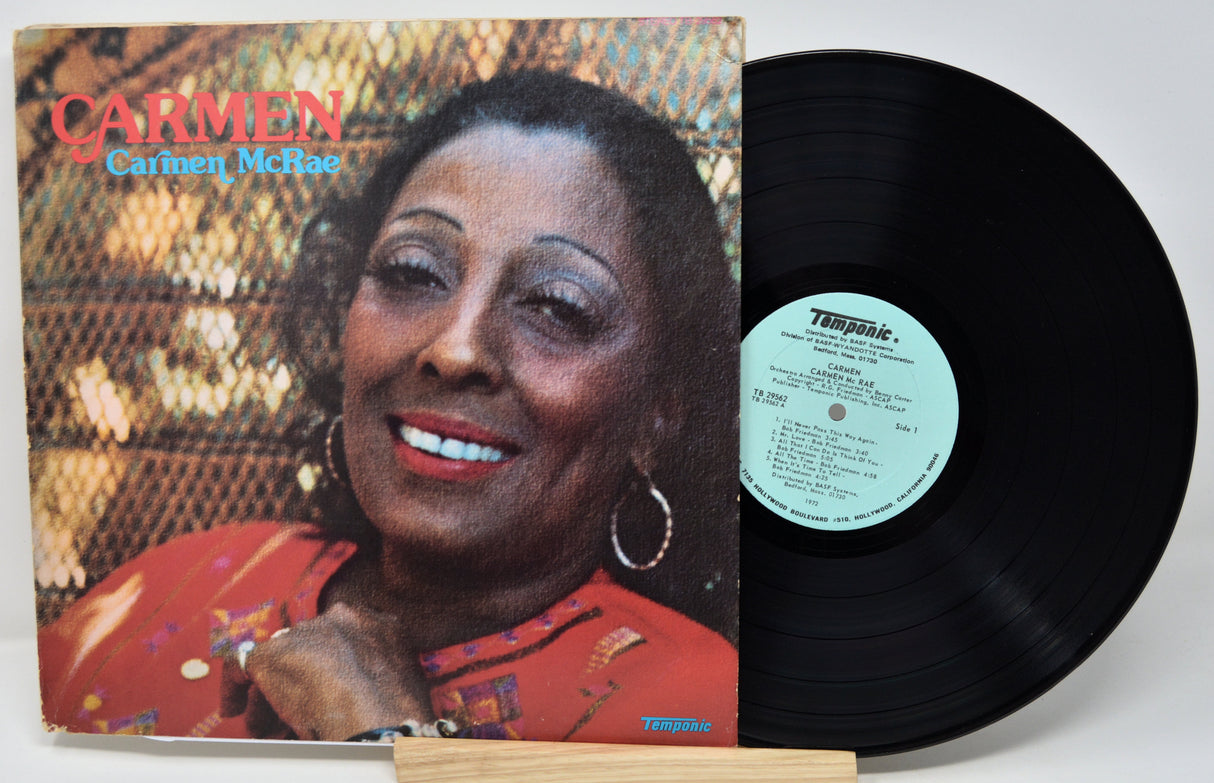 Vinyl record with cover featuring a woman's face, on a white background