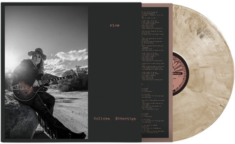 Vinyl record with a black cover featuring Melissa Etheridge playing guitar, set against a desert landscape.