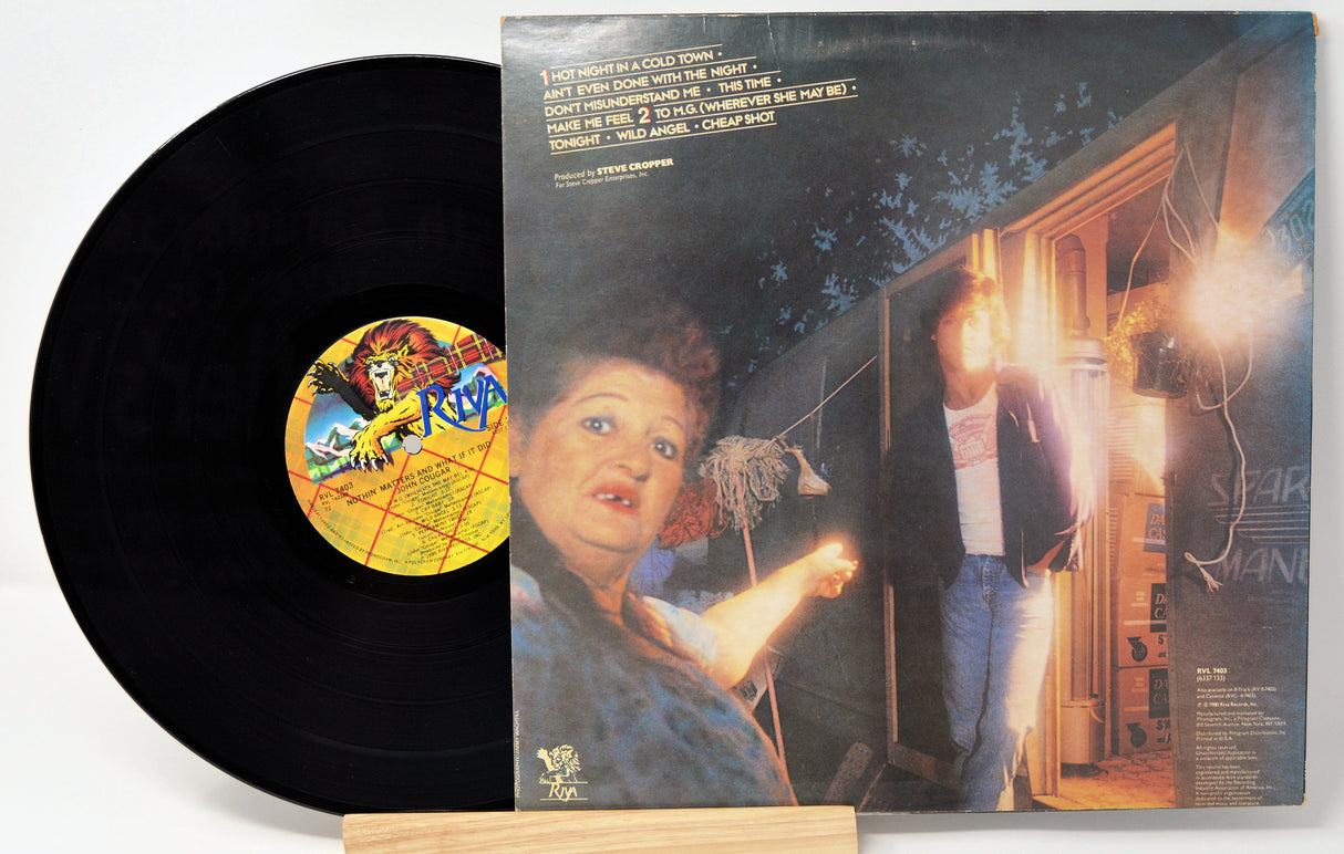 Vinyl record by John Cougar with a picture of him outside a trailer/camper and a woman pointing at him.