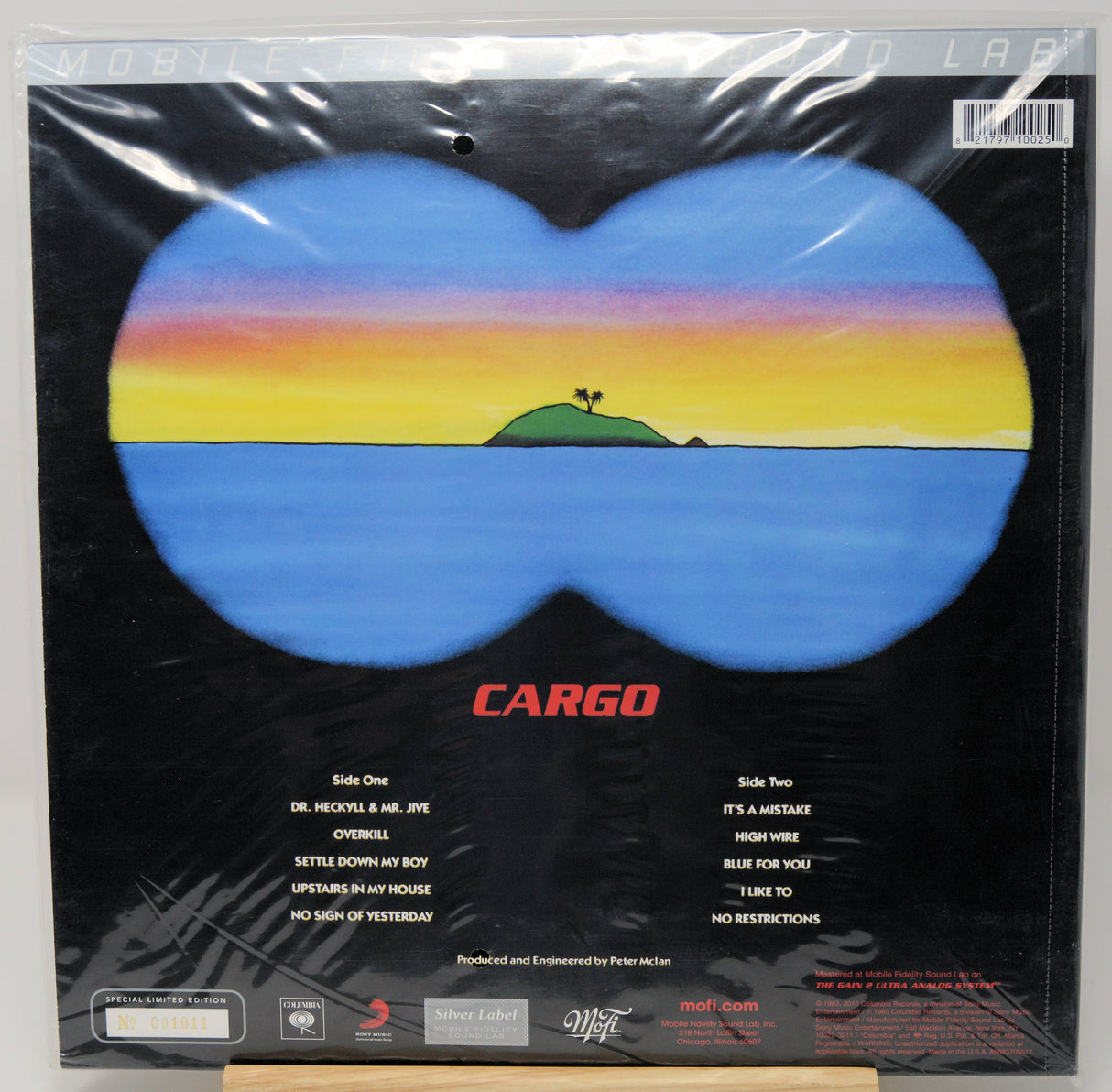 Cargo band 'Life of the Party' vinyl record cover, shrink-wrapped in plastic, featuring a blue butterfly-shaped landscape with a sunset gradient and a small green island on a black background.