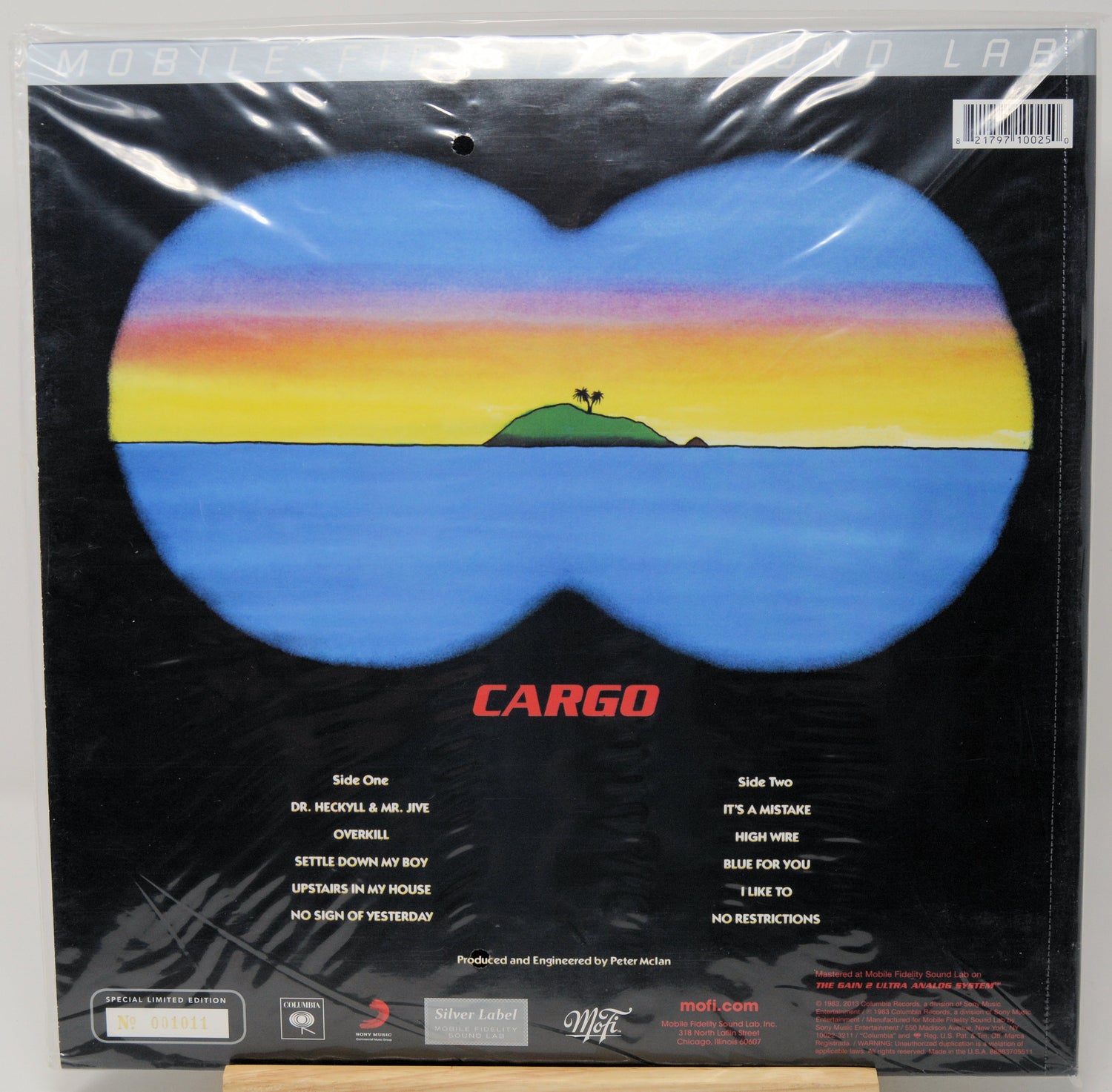 Cargo band 'Life of the Party' vinyl record cover, shrink-wrapped in plastic, featuring a blue butterfly-shaped landscape with a sunset gradient and a small green island on a black background.