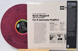 Merle Haggard & The Strangers 'I'm A Lonesome Fugitive' vinyl record LP shown with the printed album cover insert. The record is a maroon/burgundy color with a black center label featuring a rainbow gradient ring.
