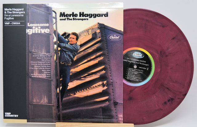 Merle Haggard and The Strangers 'Lonesome Wintertime' vinyl record LP with its cover sleeve, featuring a maroon marbled record and a black inner label.