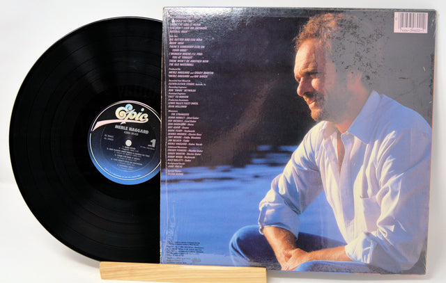 Back cover and vinyl record of Merle Haggard's Kern River LP showing song list and artist portrait