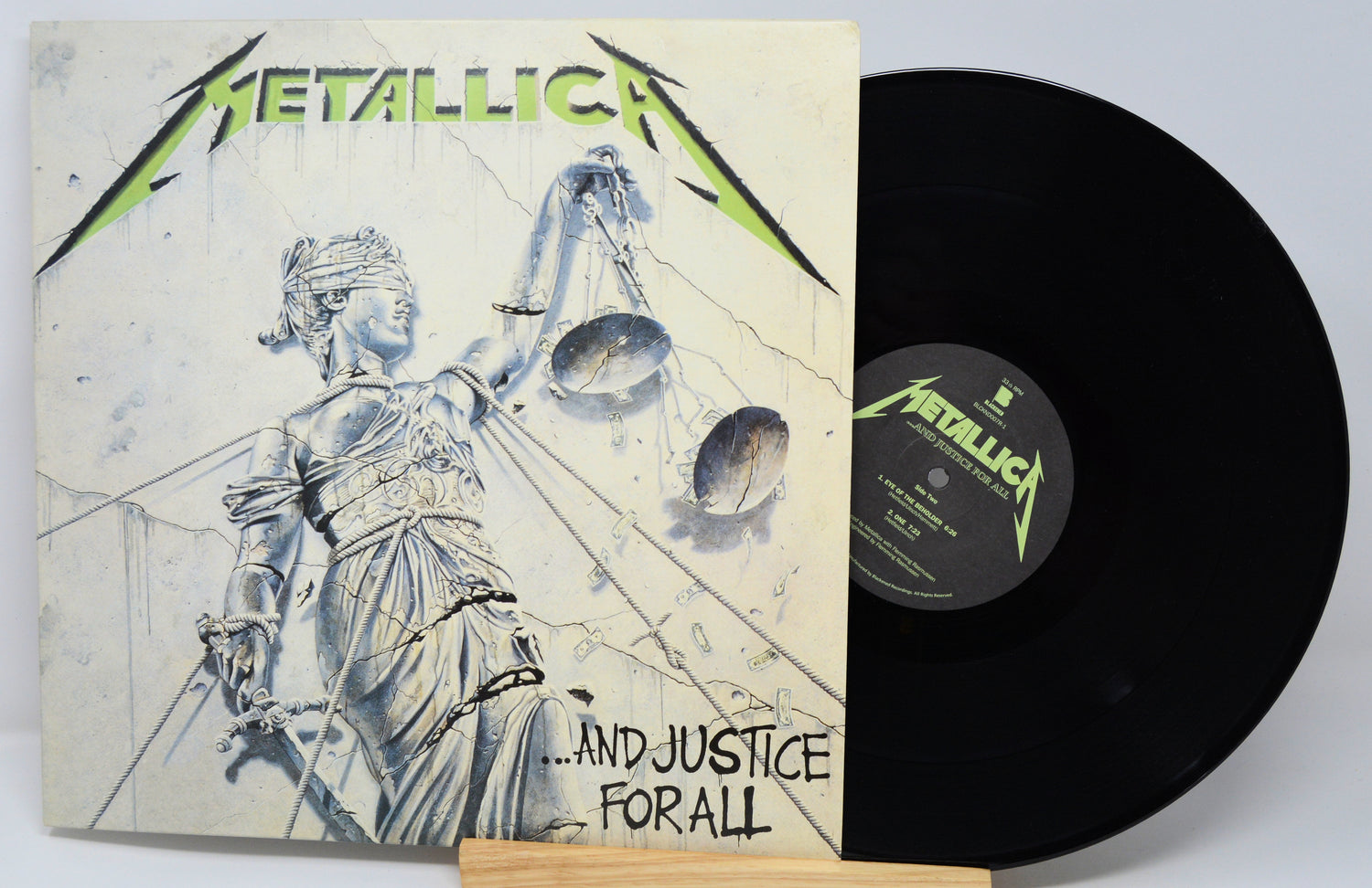 Metallica Justive for All cover featuring a statue with green writing