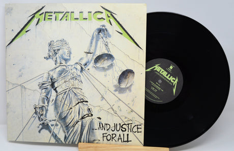 Metallica Justive for All cover featuring a statue with green writing