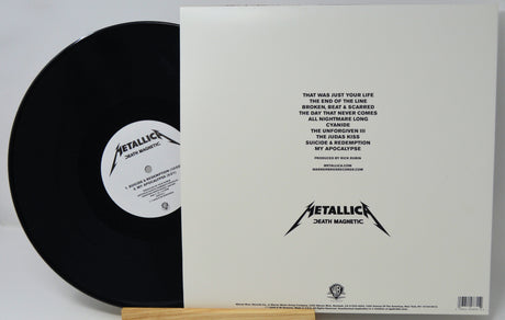 Metallica's 'Death Magnetic' vinyl record shown with its outer sleeve, featuring the black record partially pulled from the white sleeve with tracklist text and the Metallica logo.