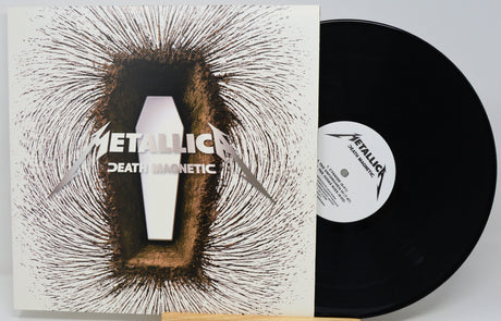 Metallica's 'Death Magnetic' vinyl record shown with its illustrated album cover sleeve and the black LP partially pulled out, on a light gray background.