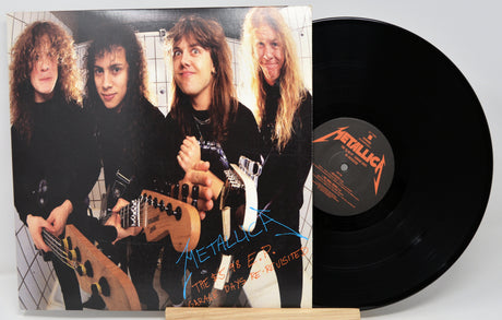 Vinyl record with a cover featuring a band and 'Metallica' branding.