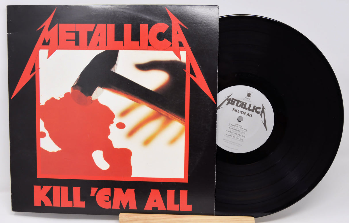 Vinyl record and cover of Metallica's 'Kill 'Em All' album on a white background