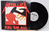 Vinyl record and cover of Metallica's 'Kill 'Em All' album on a white background