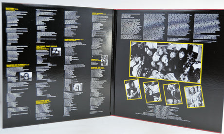 An gatefold cover with a black cover, showing printed text columns and several black-and-white photos outlined in yellow. 