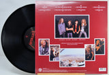 Metallica vinyl record LP with the black record partially visible behind the back cover, photographed on a white background.