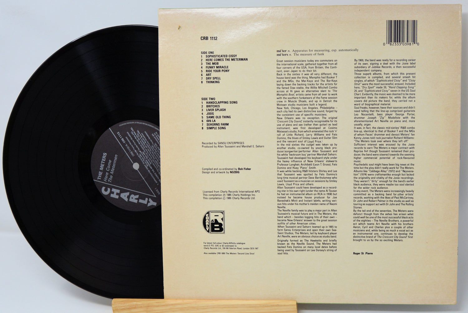 Vinyl record with its cover displaying text on a light gray background