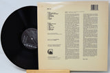 Vinyl record with its cover displaying text on a light gray background