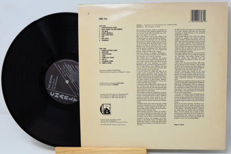 Vinyl record with its cover displaying text on a light gray background