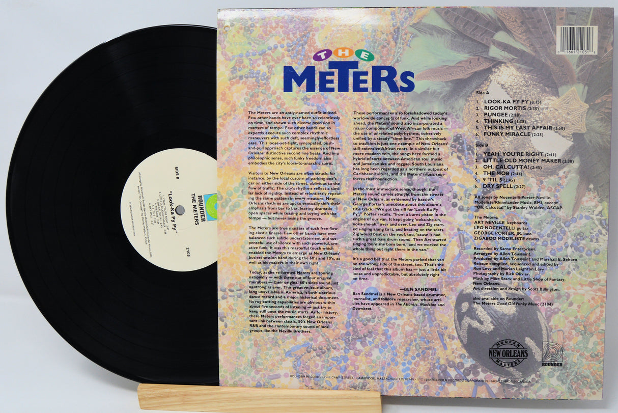 Vinyl record with colorful cover featuring 'The Meters' on a light gray background