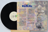 Vinyl record with colorful cover featuring 'The Meters' on a light gray background