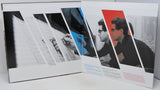 A square art print or poster displayed open against a white background, featuring a collage of diagonal black-and-white and color photo panels with small text blocks.