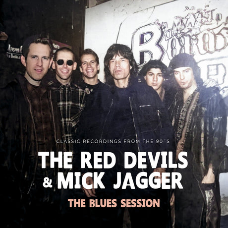 Group of men posing together with text about 'The Red Devils & Mick Jagger' and 'The Blues Session'.