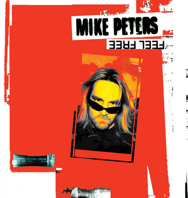 Album cover with a stylized portrait of a person with sunglasses on a red background, featuring the text 'Mike Peters' and 'Feel Free'.
