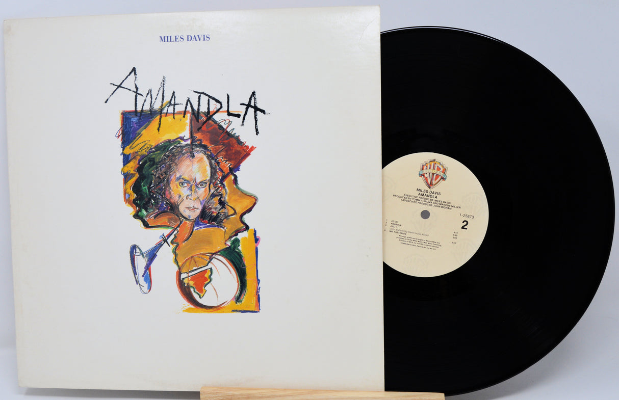 Vinyl record with cover featuring Miles Davis and 'Mandela' text on a white background