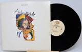 Vinyl record with cover featuring Miles Davis and 'Mandela' text on a white background