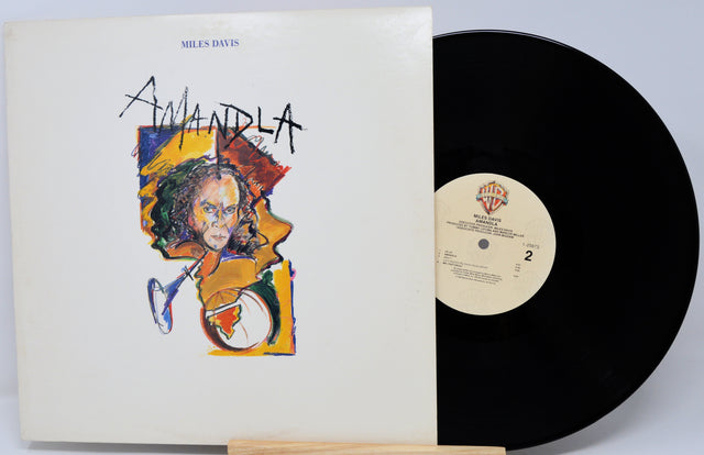 Vinyl record with cover featuring Miles Davis and 'Mandela' text on a white background