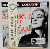 A vinyl record sleeve for Miles Davis' 'As a Teacher for All' (1958), featuring a black-and-white portrait of a woman, large red title text, and a cream vertical ribbon label with the title and Montana logo. A white barcode sticker is visible in the top right corner.