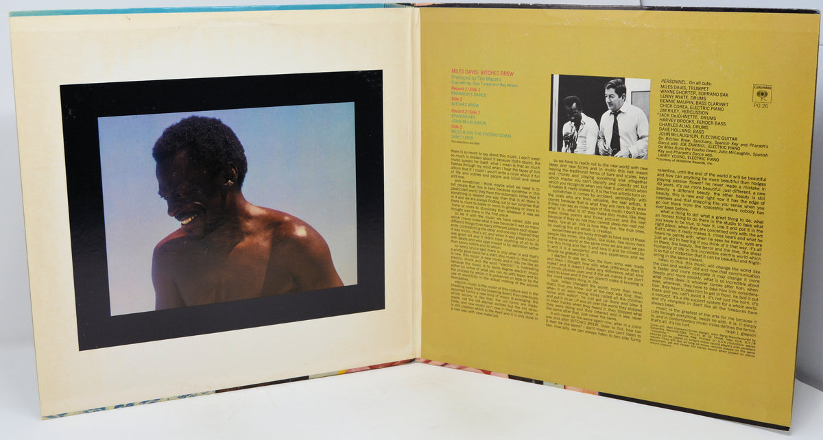 An open printed booklet or album-style book shown against a plain white background. The left page features a large black-framed portrait photograph of a shirtless person against a pale blue sky.