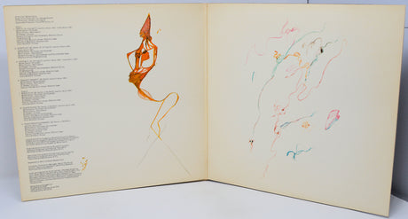 Open book with artistic illustrations of a dancer and abstract shapes on a light background.
