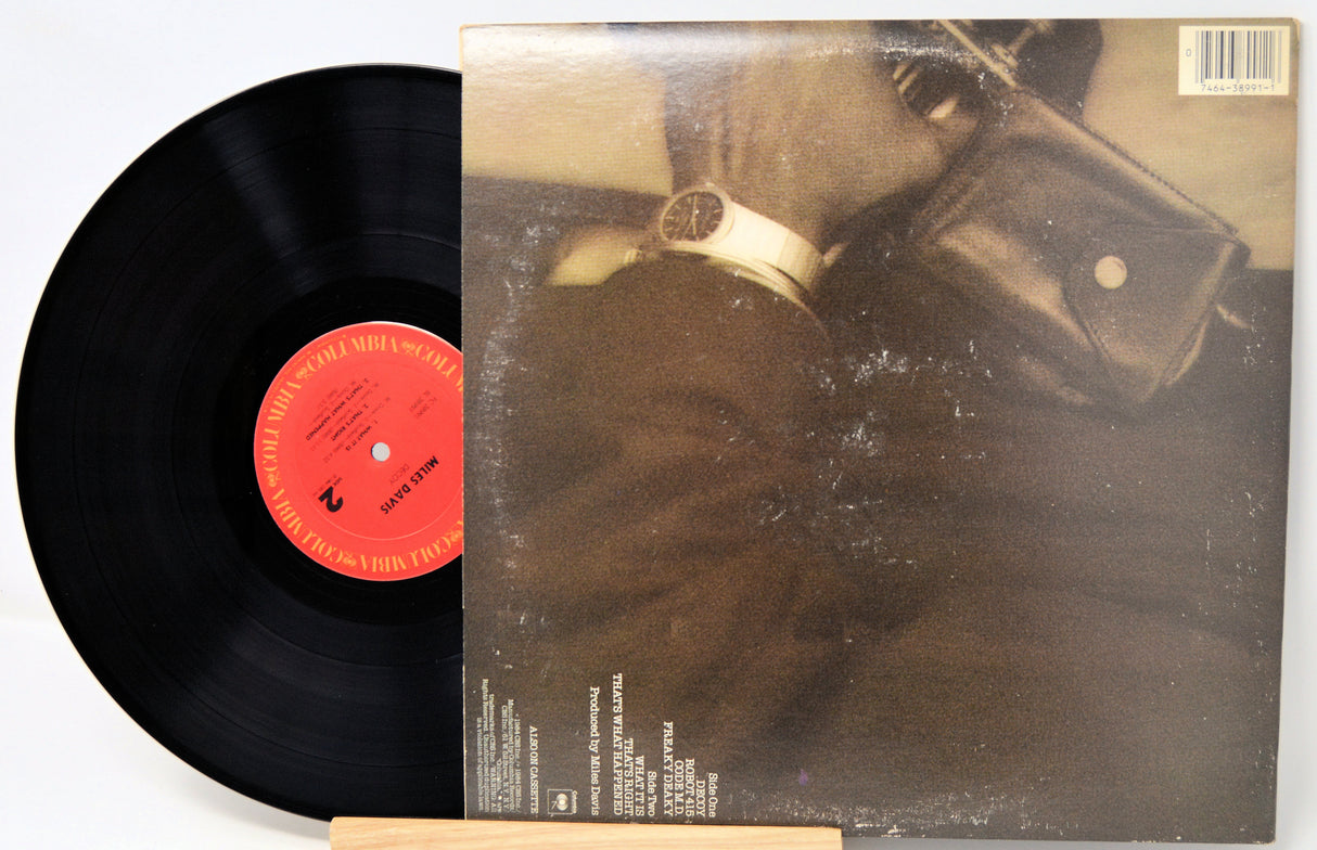 Vinyl record with a black disc and red label, and a cover featuring a person in a helmet.