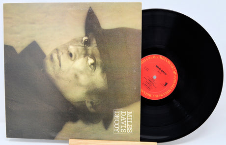Vinyl record with cover featuring a portrait and 'Miles Davis Decoy' text.