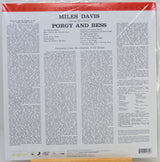The back cover of a vinyl record sleeve for Miles Davis's 'Porgy and Bess' on Columbia Records, wrapped in protective plastic. The cover features a white background with black text, a red top banner.