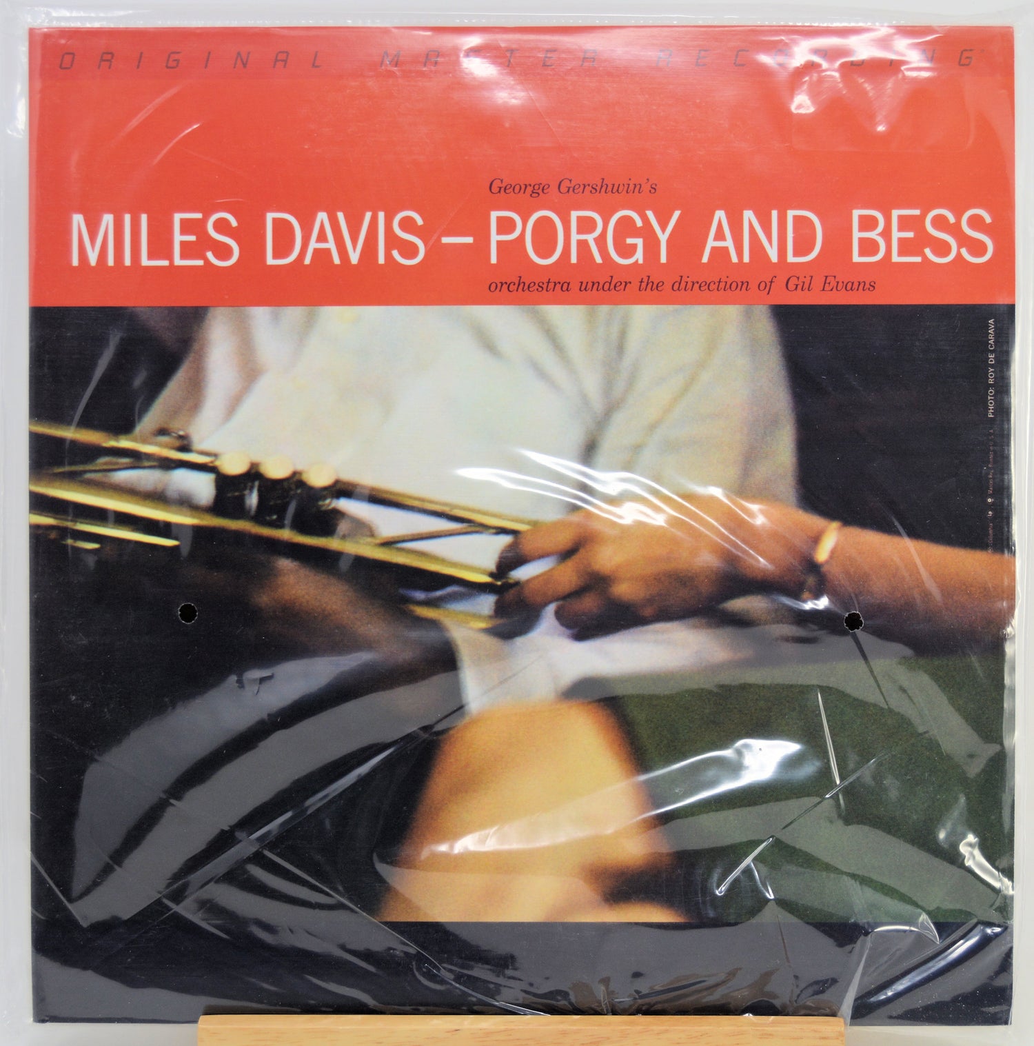 Miles Davis - Porgy and Bess album cover on a vinyl record, wrapped in protective plastic. The cover features a bright red-orange header with white text and a photograph.