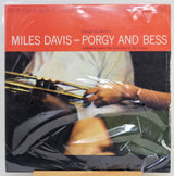 Miles Davis - Porgy and Bess album cover on a vinyl record, wrapped in protective plastic. The cover features a bright red-orange header with white text and a photograph.