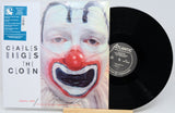 Charles Mingus 'The Clown' vinyl record LP with its illustrated cover and a black record partially visible, photographed on a light gray background.