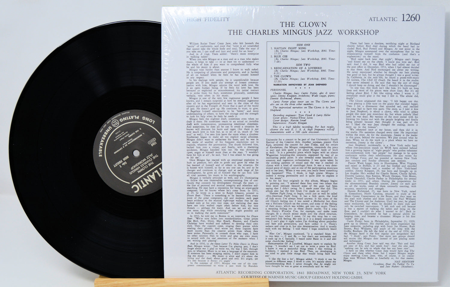 A vinyl record partially pulled from its sleeve, showing the black record and the printed cover insert for Atlantic's 'The Clown: The Charles Mingus Jazz Workshop'.