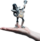 Hand holding a detailed mini rock guitarist figurine in full costume