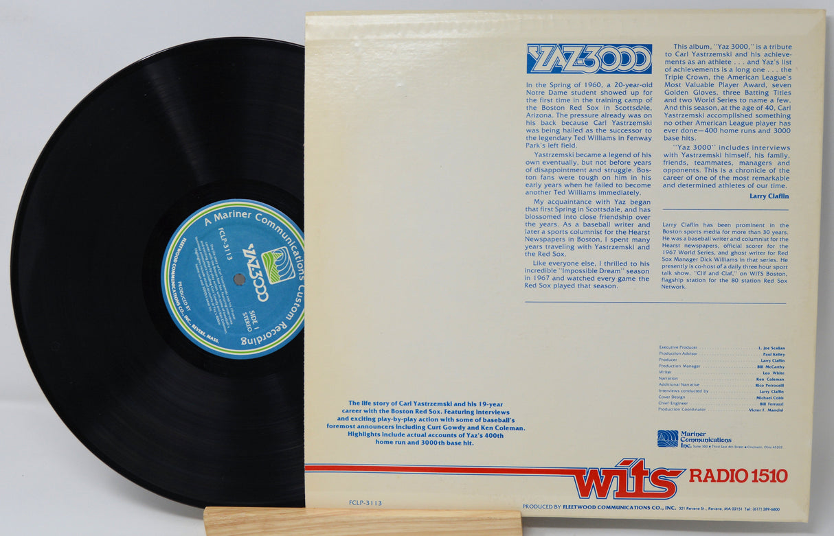 Vinyl record with a white sleeve featuring text and logos on a light gray background