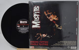 Vinyl record and its cover featuring the band 'Misfits' on a gray background