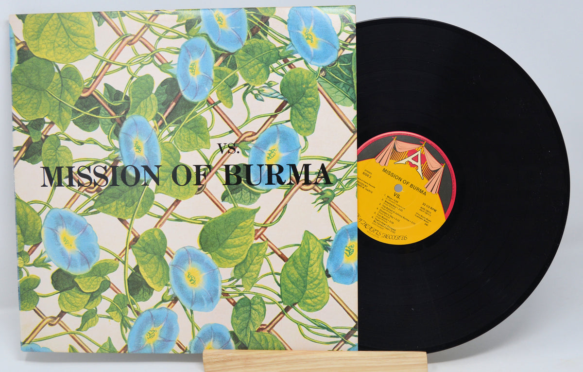 Vinyl record and album cover with a floral pattern and 'Mission Of Burma' text on the cover. The record is visible under the cover, showing the vinyl record itself.