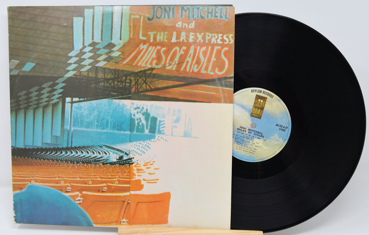 Vinyl record with cover featuring a colorful design of a theater auditorium.