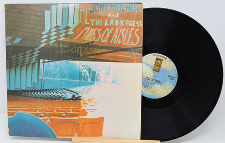 Vinyl record with cover featuring a colorful design of a theater auditorium.