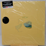 A 12-inch vinyl record sleeve for Jazzy Vinyl's 'Court And Spark' album, featuring a pale yellow cover with a minimalist illustration of a woman and landscape, sealed in clear plastic wrap with a black sticker label at the top left.