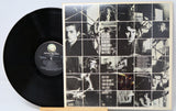 Vinyl record with a collage-style cover featuring black and white images of a person.